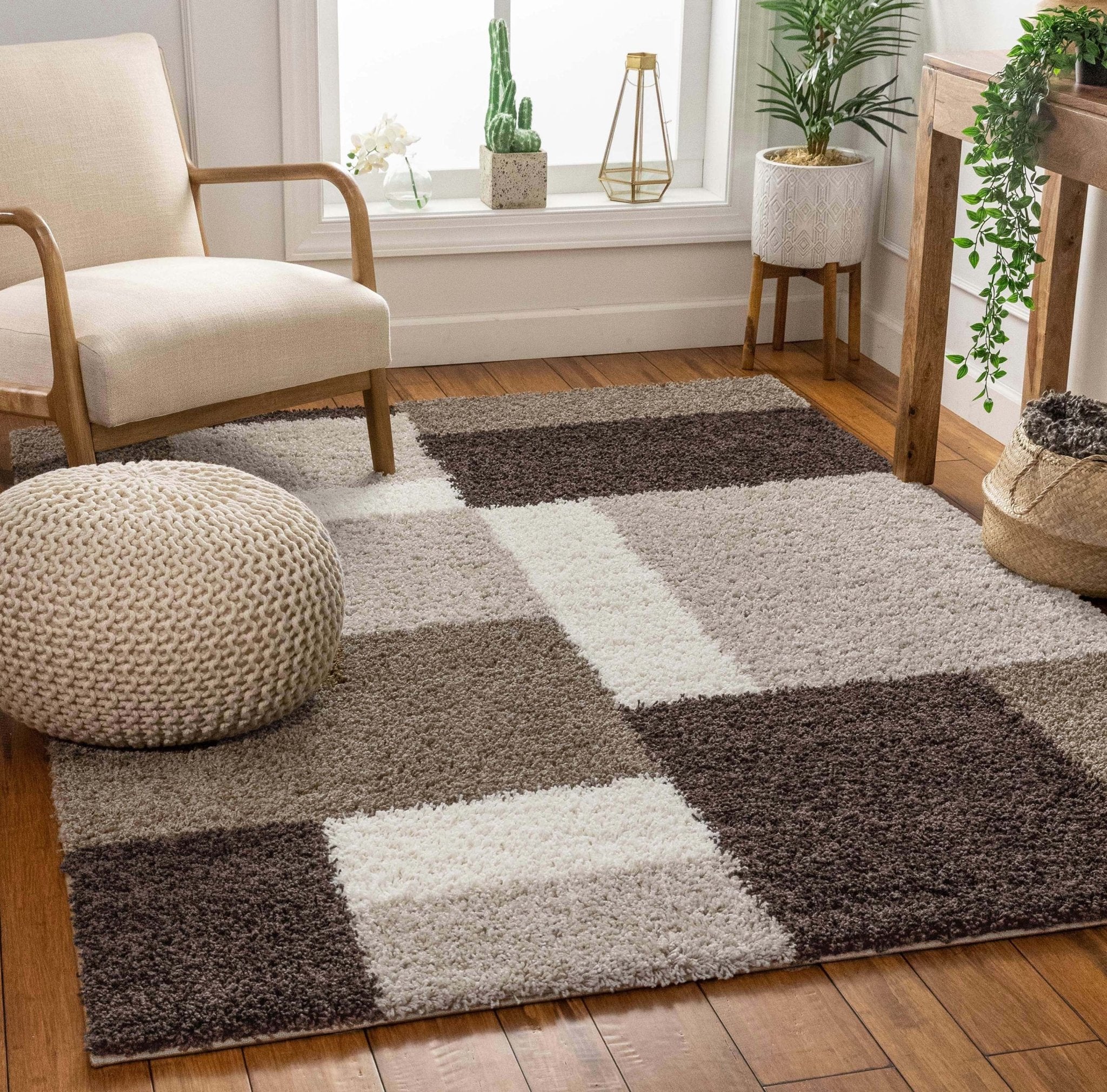 Cubes Beige Brown Modern Geo Rug - Well Woven - A modern shag rug with a bold geometric checkered pattern in shades of dark brown, ivory, and taupe, styled in a cozy living room with wooden floors and neutral furniture.