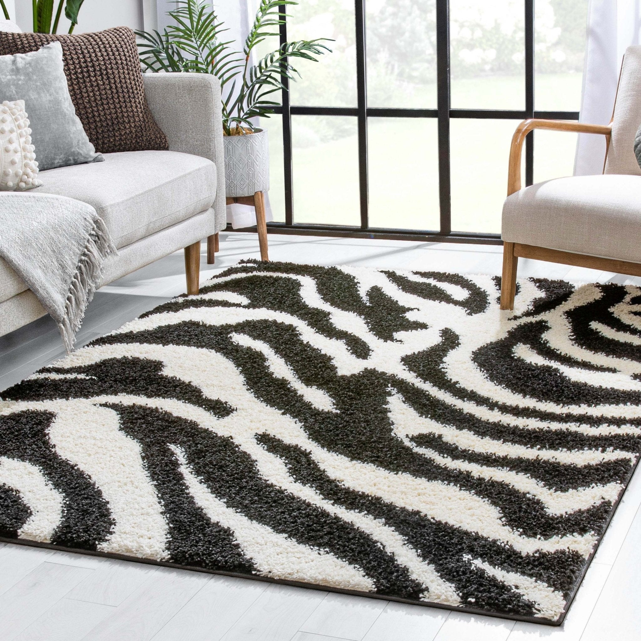 Safari Zebra Black Contemporary Shag Rug - Well Woven - Living room view room emphasizing the rug’s ability to ground a space with strong graphic impact.