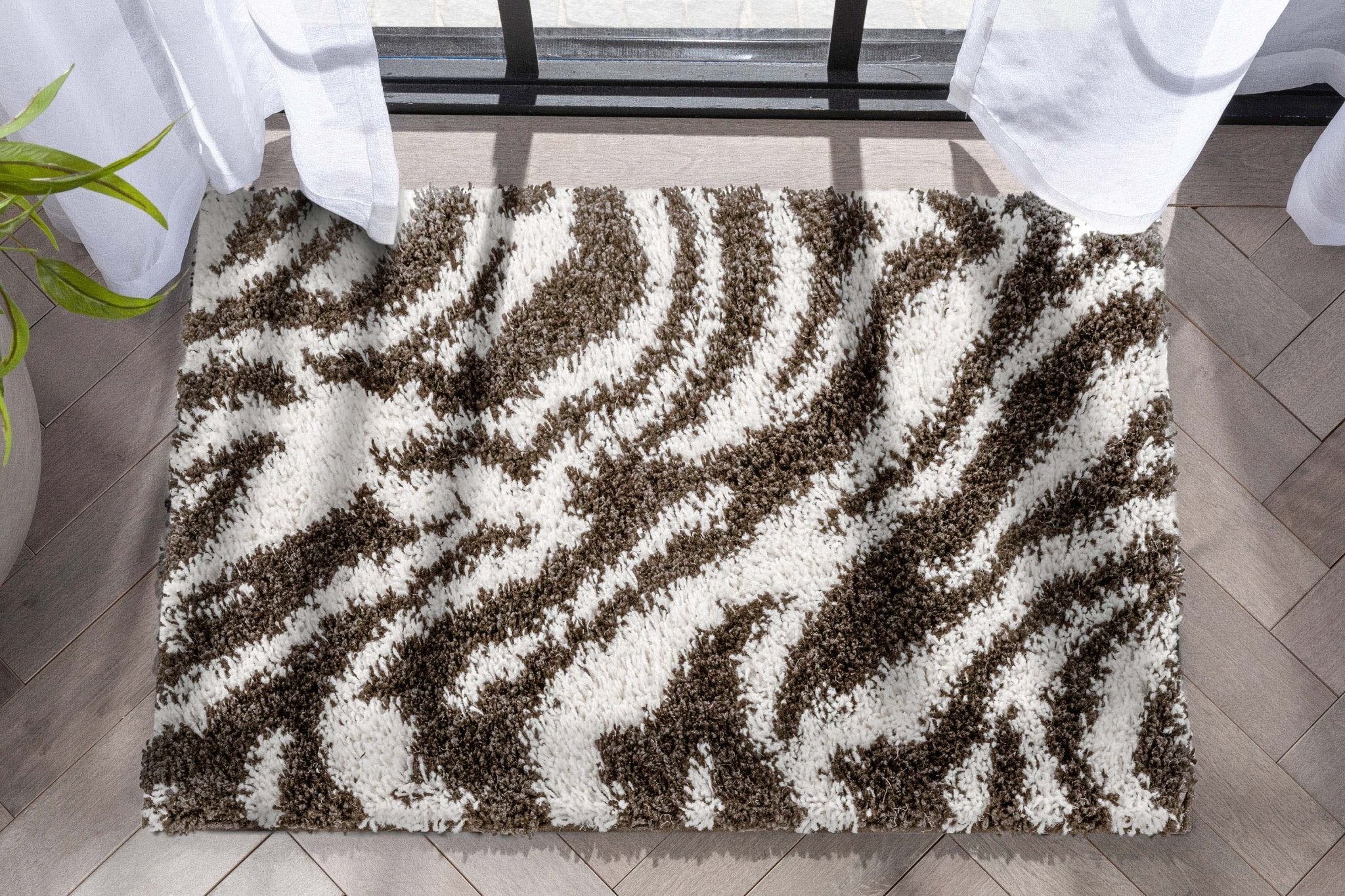 Safari Zebra Brown Contemporary Shag Rug - Well Woven - top-down view of a zebra accent rug laid across a modern entry space.