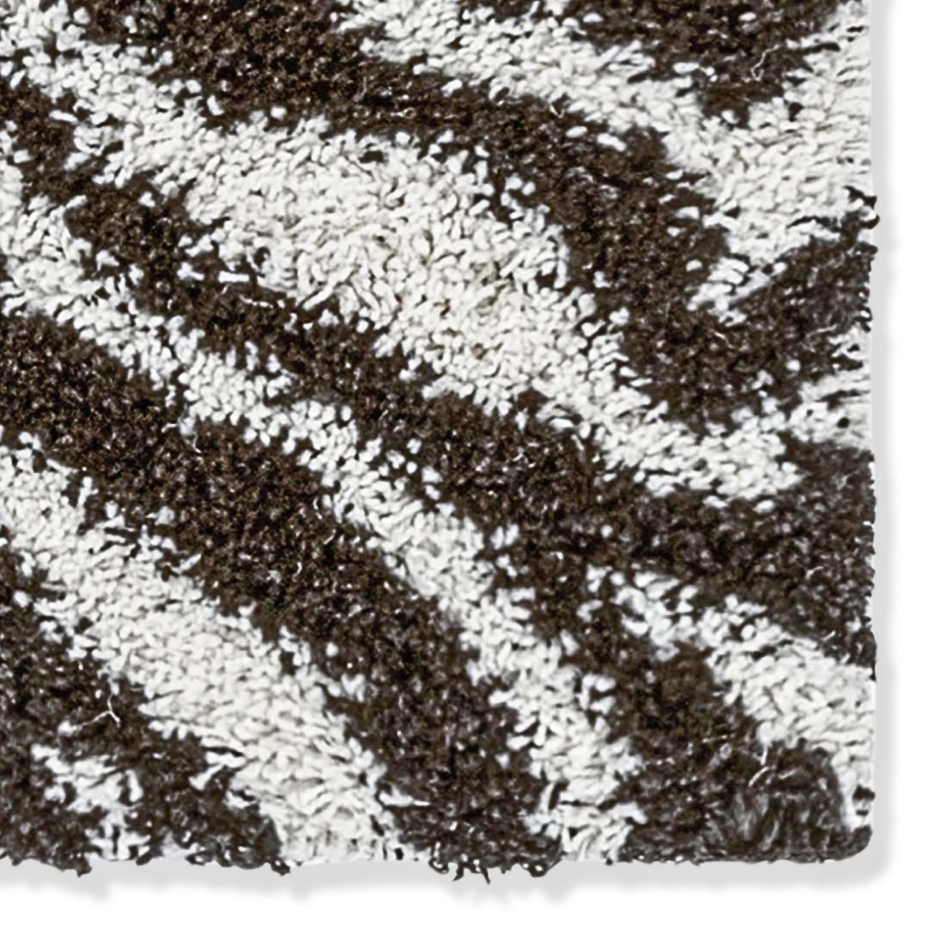 Close-up of a textured brown and white zebra patterned shag rug