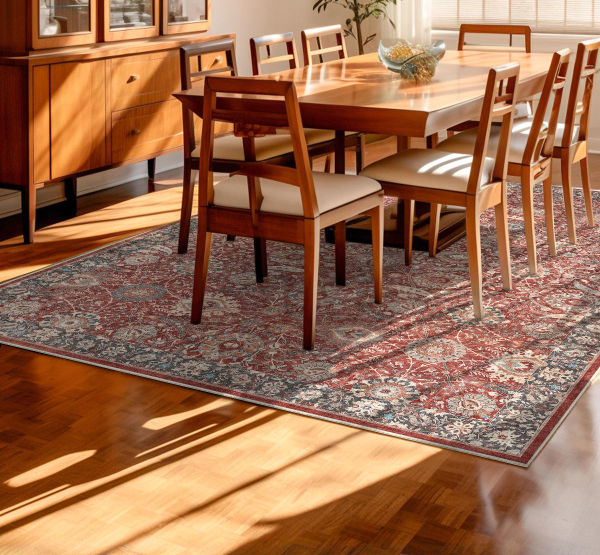 Dining room with wooden table and chairs on a floral patterned red rug