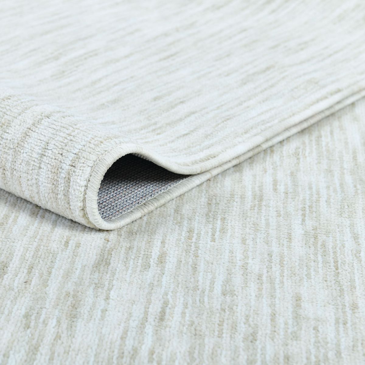 Close-up of an ivory-cream rug with a slight sheen