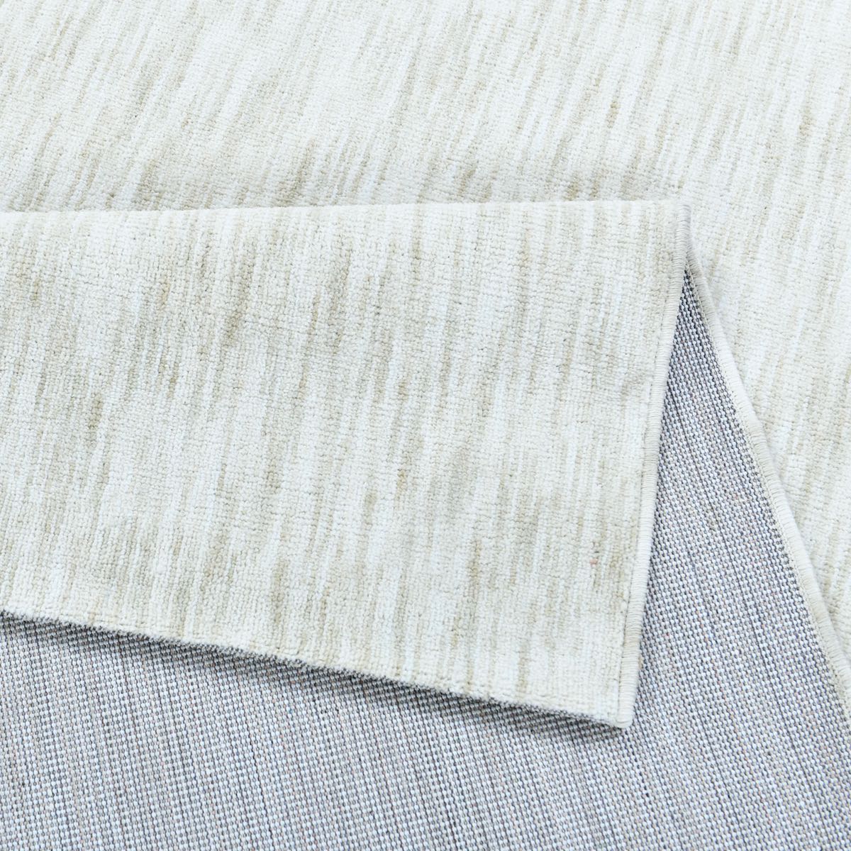 COD-12 Well Woven Moor Washable Rug: Close-up of the white and cream piled rug displaying its softness and flexibility