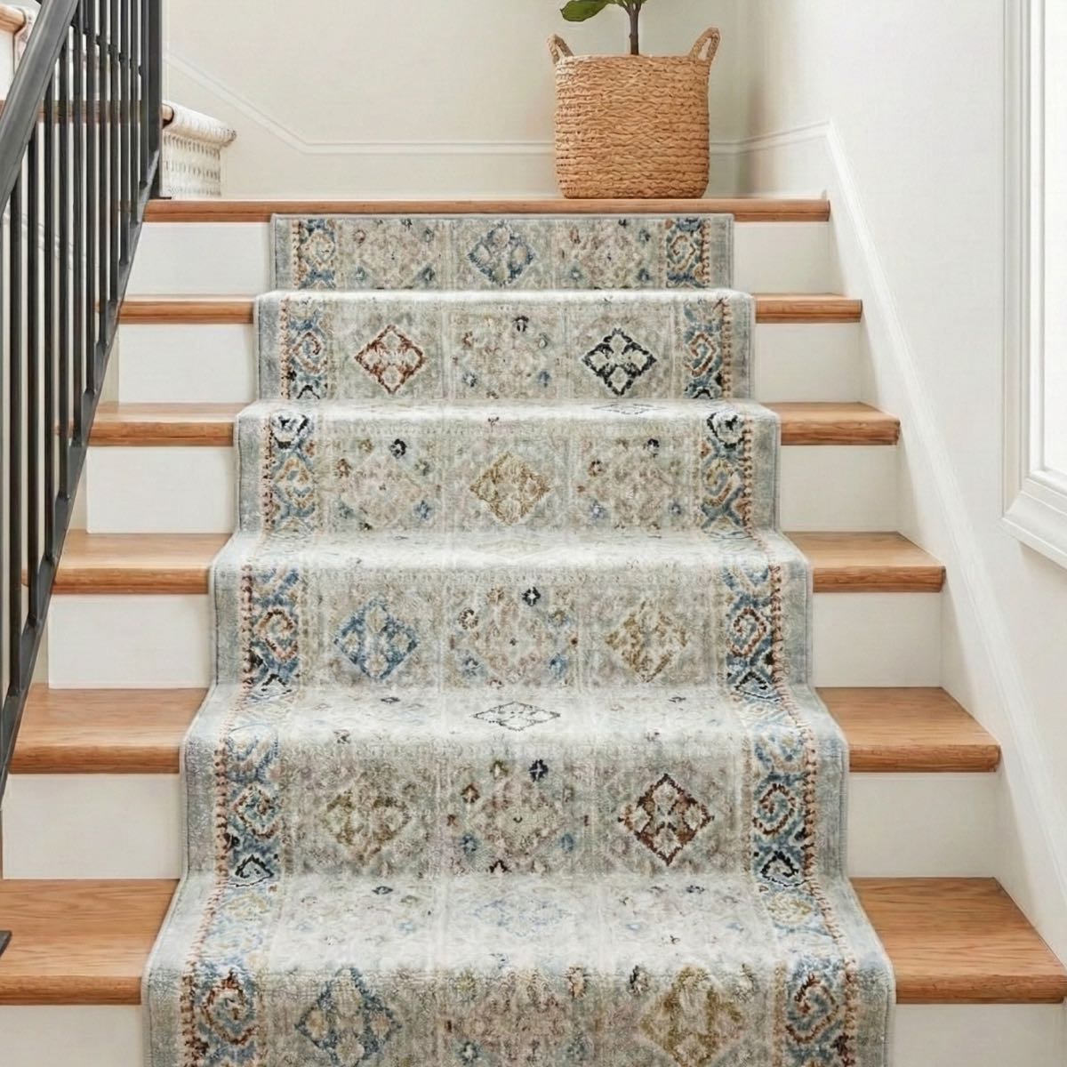 COD-21 - Staircase with a multicolor, patterned washable rug running up the steps, with a woven basket on the landing.