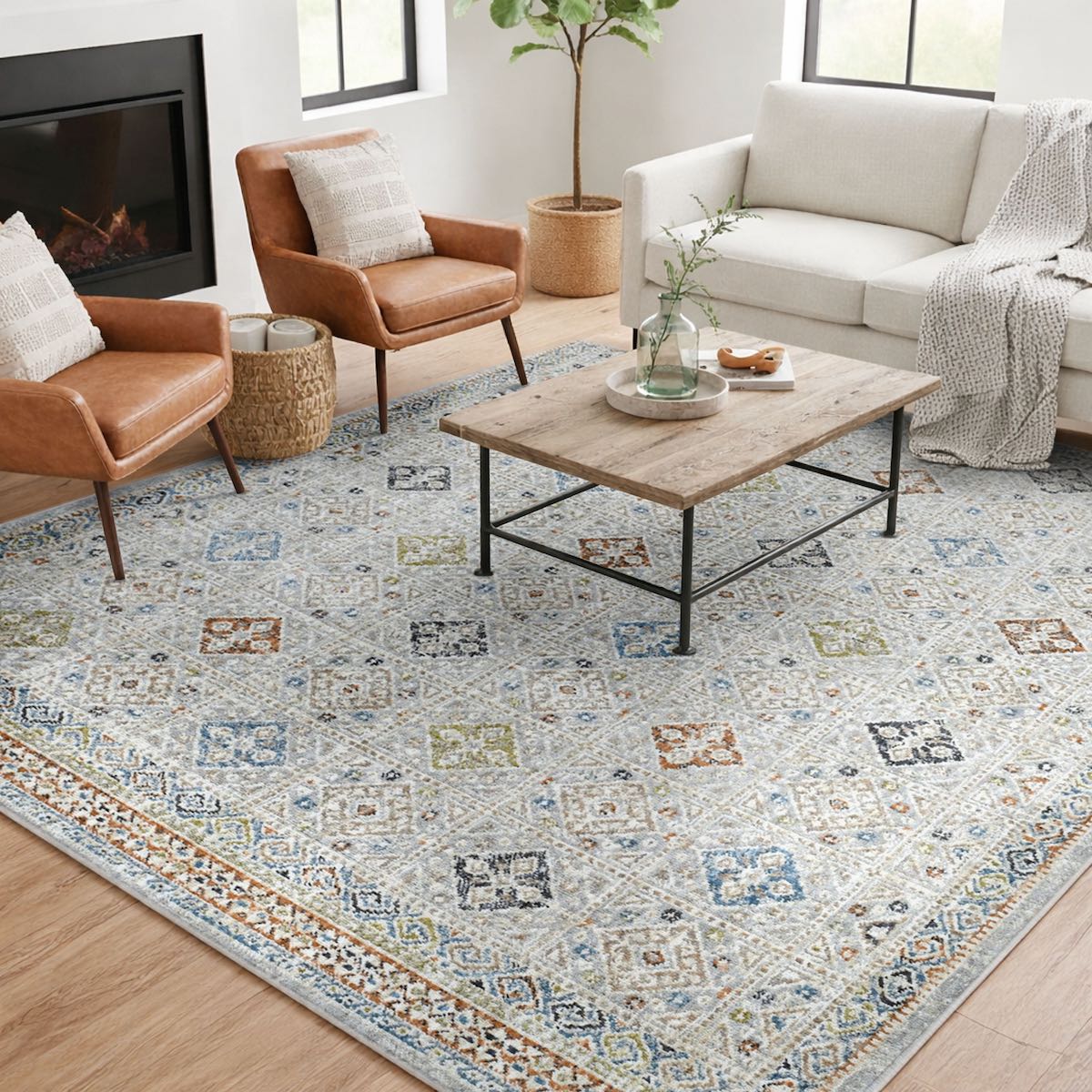 COD-21 Well Woven Mere Washable Rug - Living room with a patterned geometric rug, sofa, coffee table, and chairs.