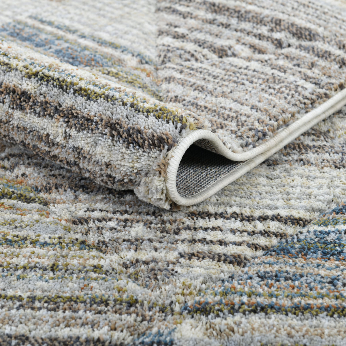ELM-11 Well Woven Knoll Washable Area Rug: Close up view of a textured area rug with a pattern of stripes and triangles in neutral- and multi-colors.
