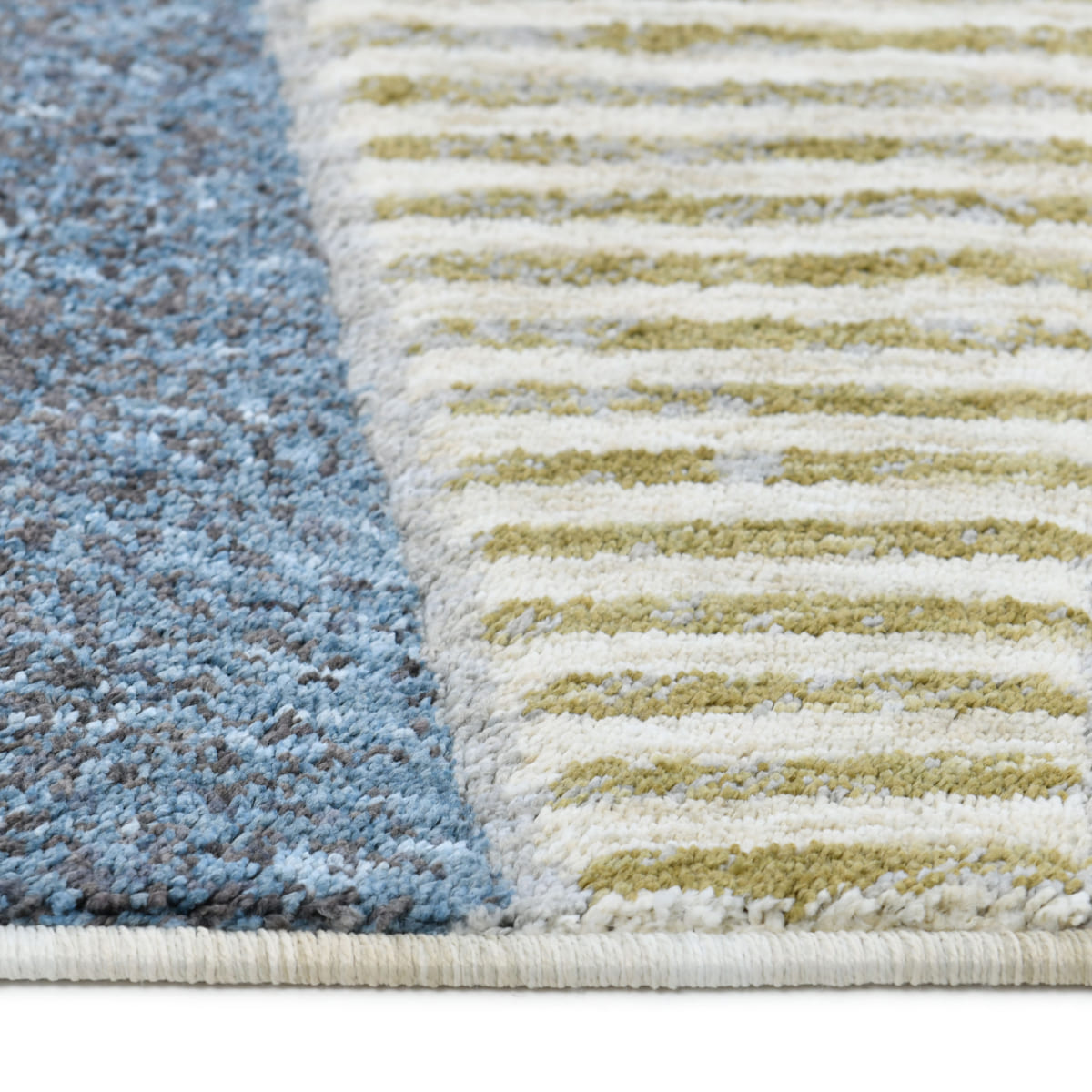 ELM-21 Well Woven Ridge Washable Area Rug: Close-up of a textured washable rug with a blue and cream striped pattern.