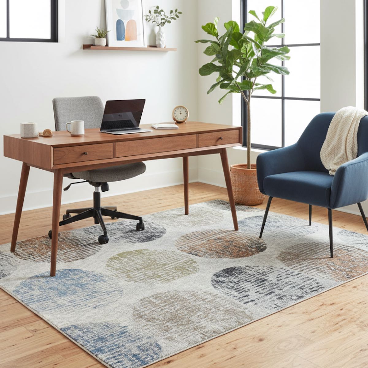 ELM-31 Well Woven Vale Washable Area Rug: Home office with wooden desk, chair, laptop, and a modern, multicolor geometric rug anchoring the room.