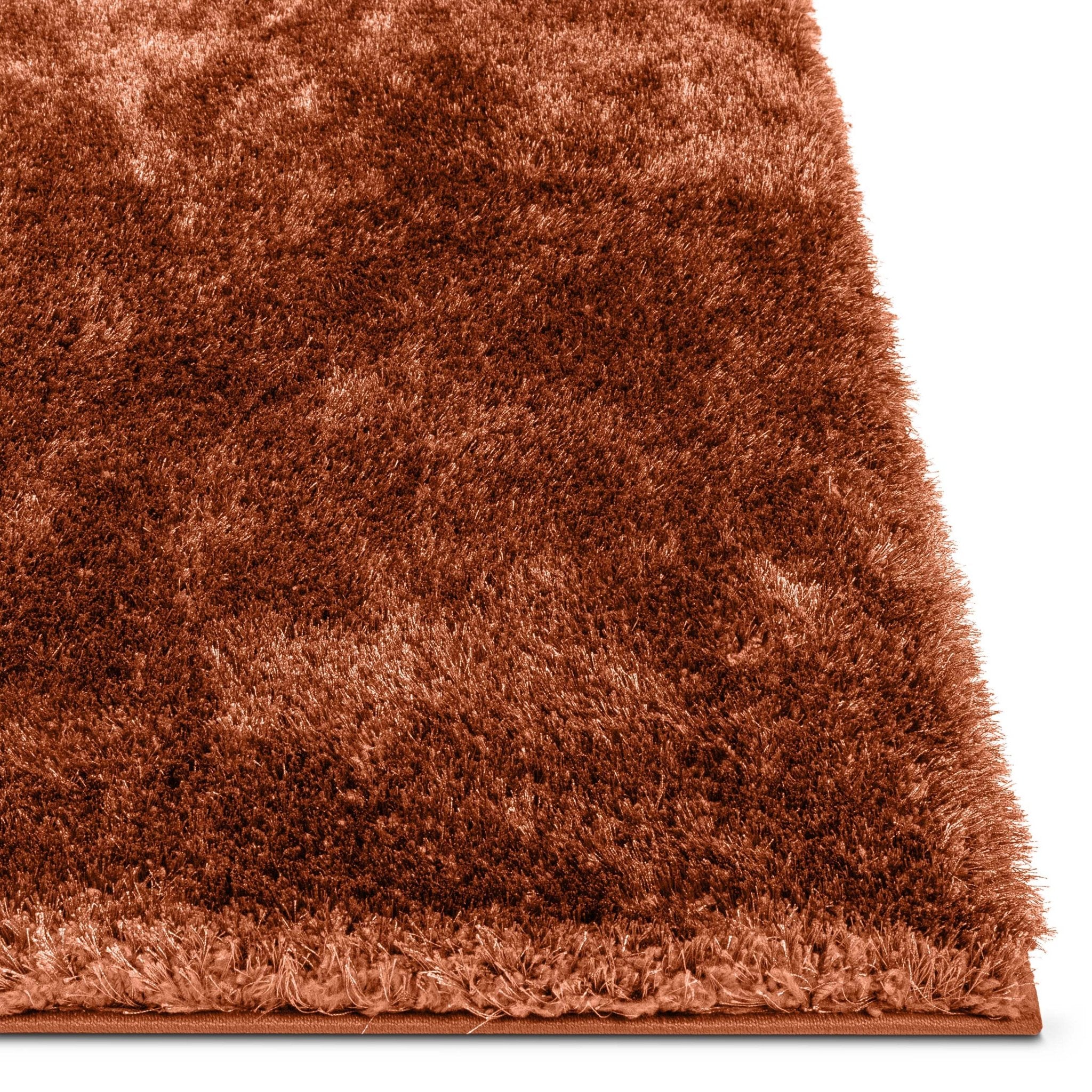 A close up corner image of the Feather Collection Liza Terracotta Shag Rug