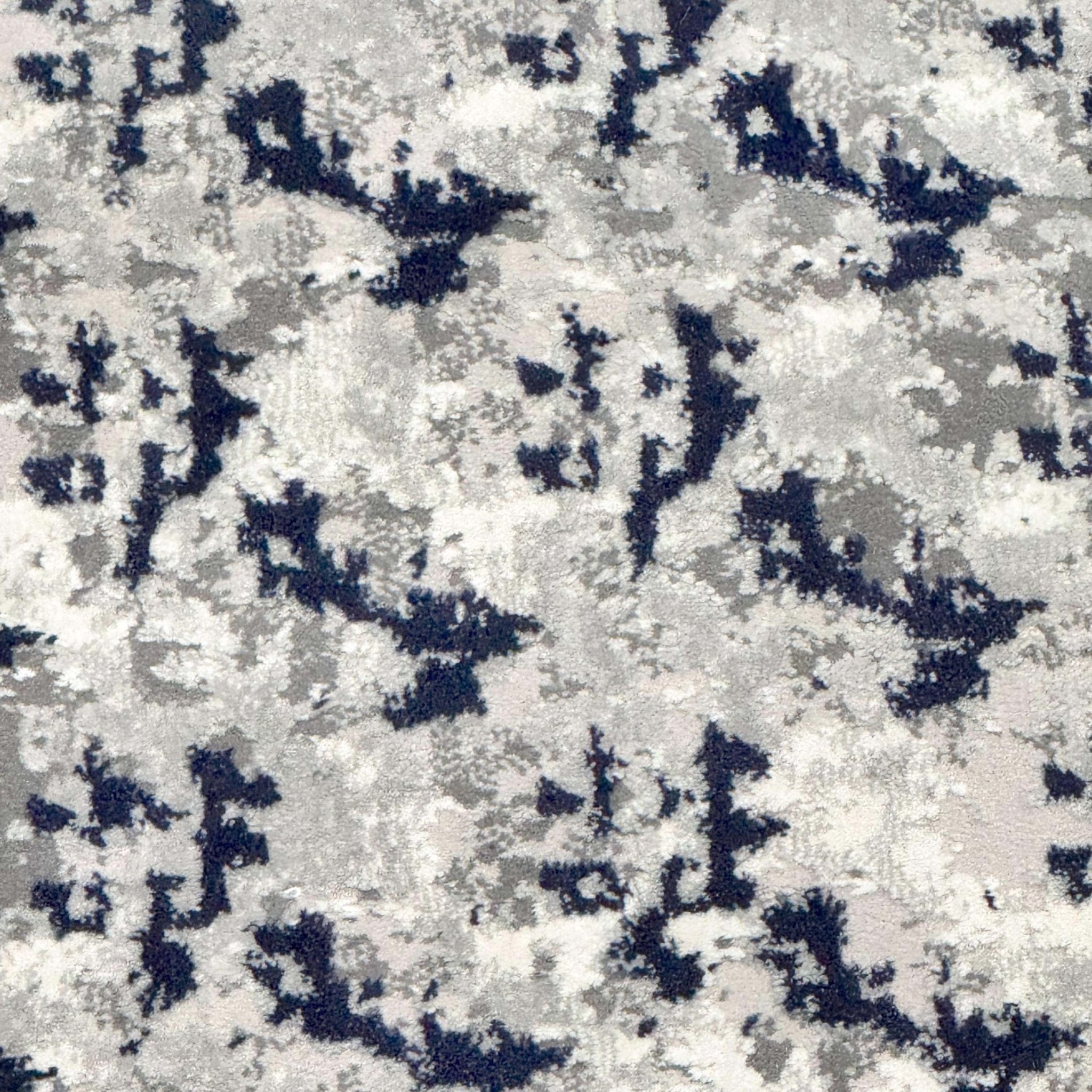 A close up view of the Shadowplay Custom Size Runner's grey and blue abstract rug pattern