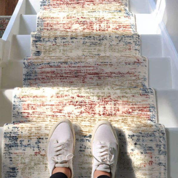 IND-151 Multicolor abstract runner rug on a staircase with white sneakers at the bottom.