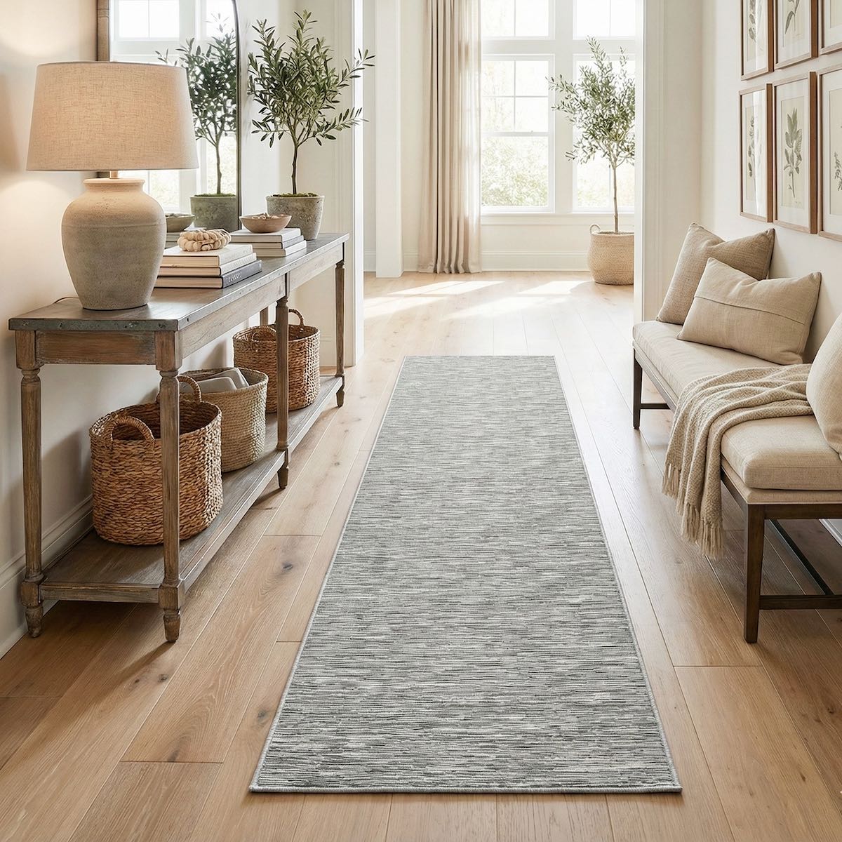 The Apollo Striations, a long, gray well woven custom size runner, in a hallway with a wooden console table, and beige sofa