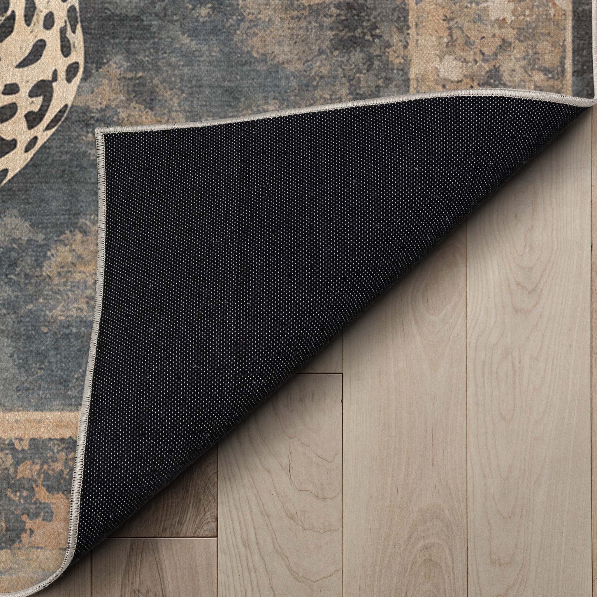 A detail image showing the soft backing of the Leopard’s Reverie Charcoal & Natural Rug