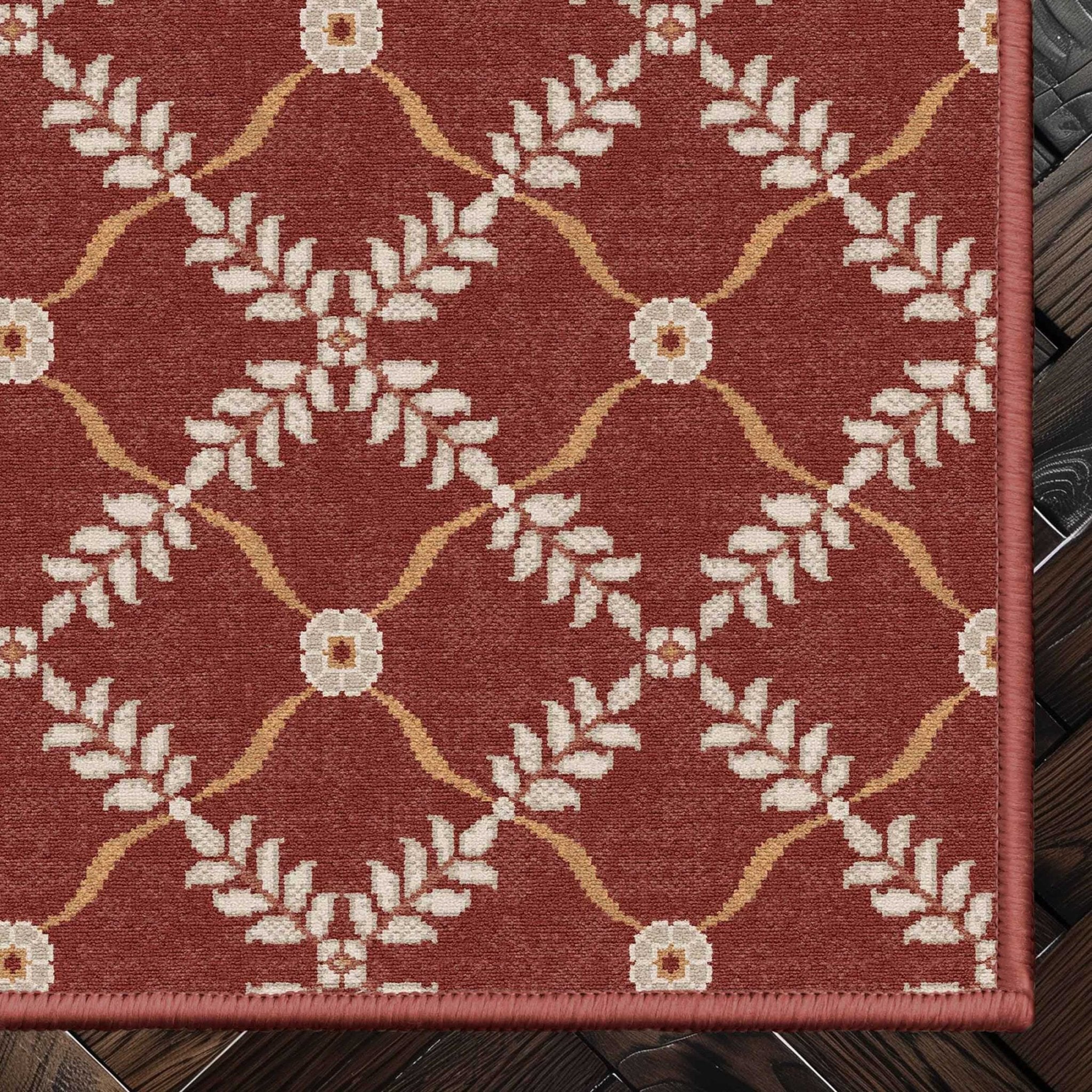 Well Woven - Aldwyn Red Custom Rug - rug corner on a dark wood floor