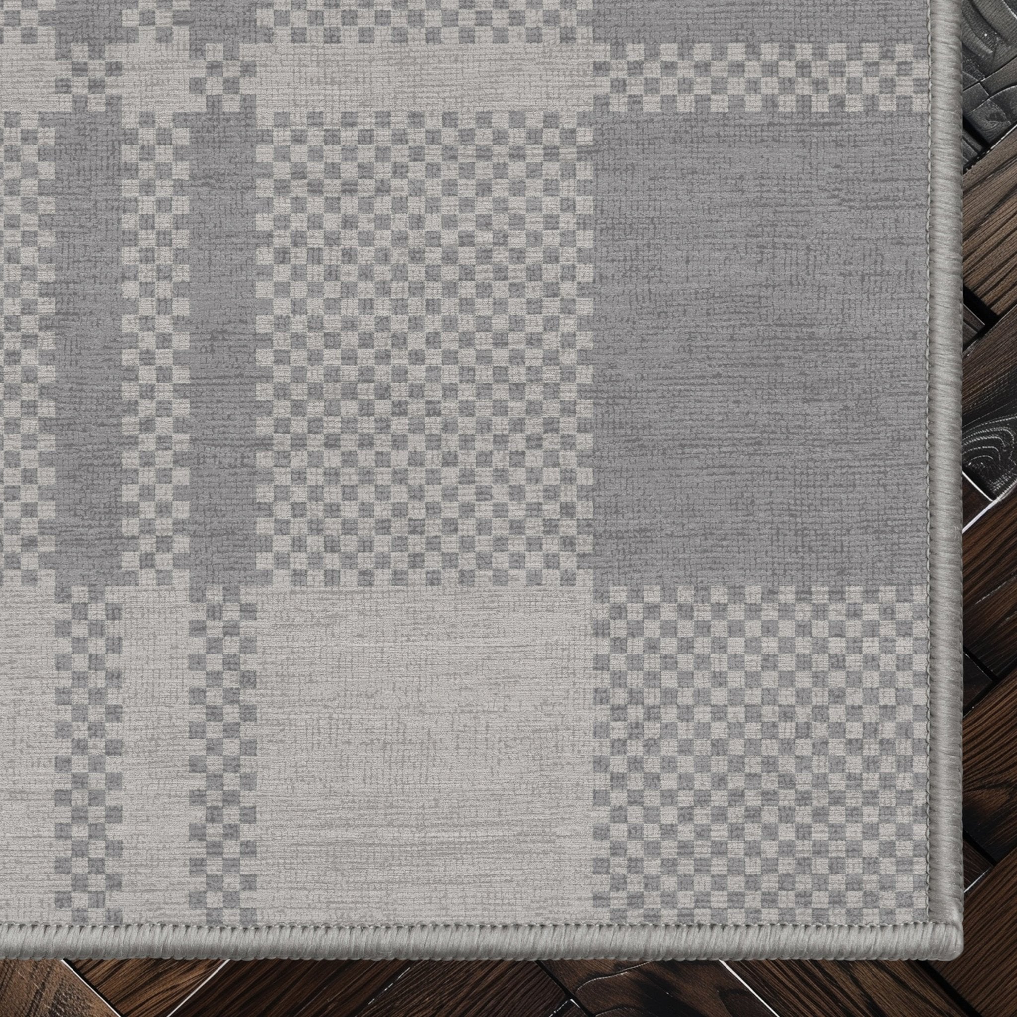 Oswald Custom Rug - Well Woven - grey rug corner on a dark wood floor