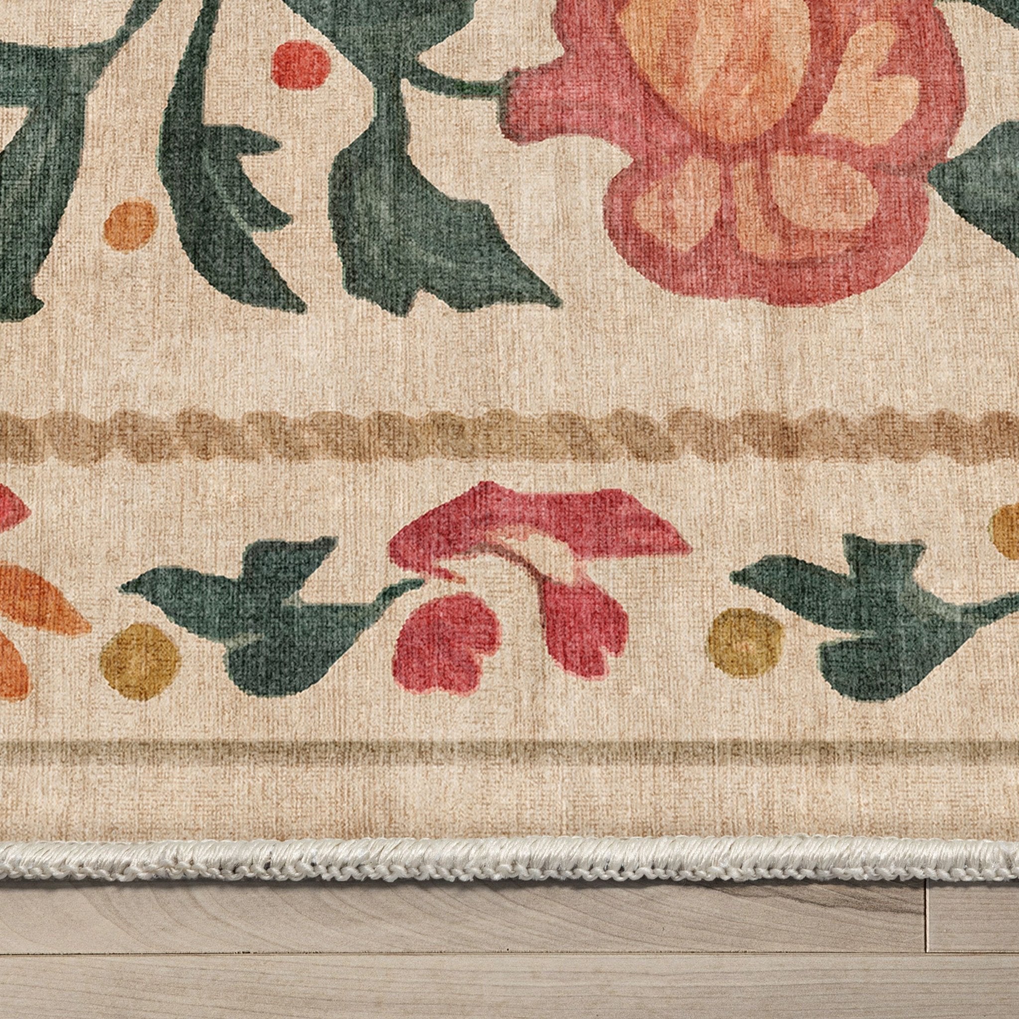 Close-up detail of the rug texture, floral patterns, and stitched edge on the Suzani Beige design.