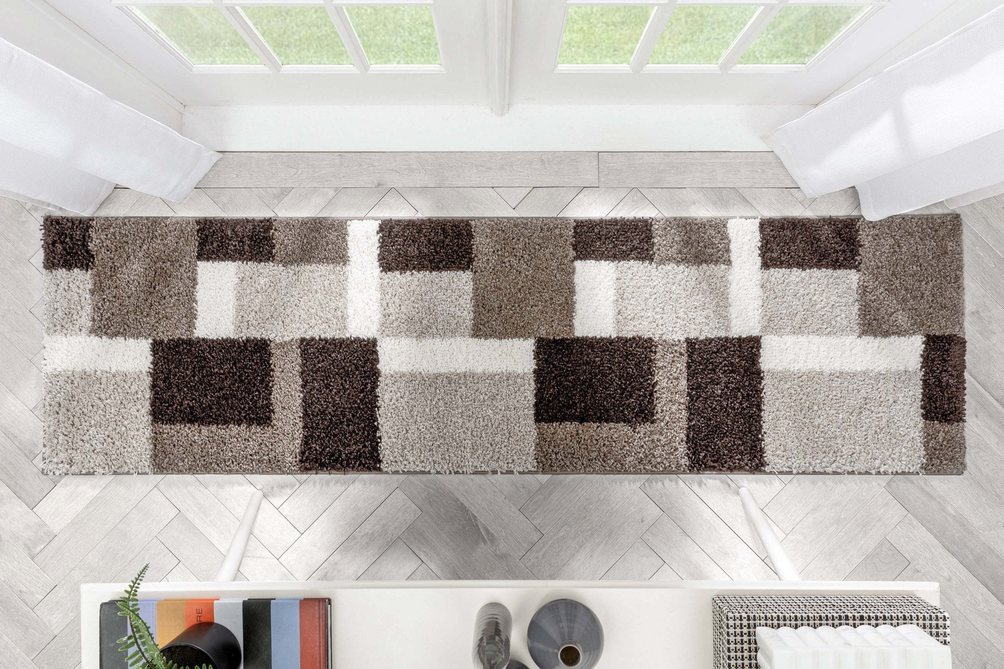 Cubes Beige Brown Modern Geo Rug - Well Woven - Top-down view of the coloblocked runner rug extending across a spacious hallway, emphasizing the repeating geometric block pattern.
