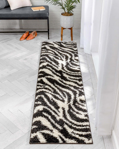Safari Zebra Black Contemporary Shag Rug - Well Woven - The runner rug styled in a light-filled hallway with white curtains and gray flooring.