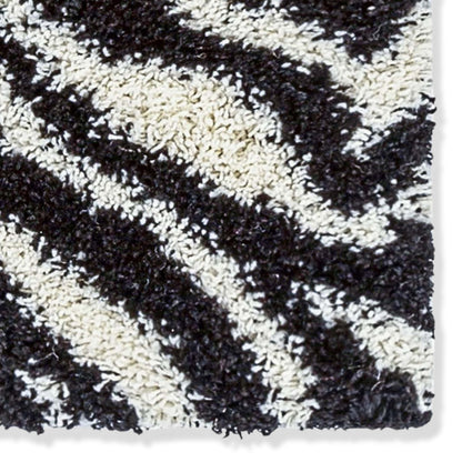Close-up of a black and white zebra patterned shag rug