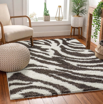 Safari Zebra Brown Contemporary Shag Rug - Well Woven - The brown zebra shag rug partially under a light armchair, showing depth and pile.
