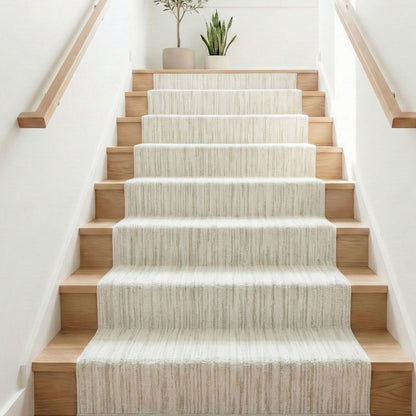 COD-12 - Staircase with wooden steps and a textured white runner, decorated with potted plants.