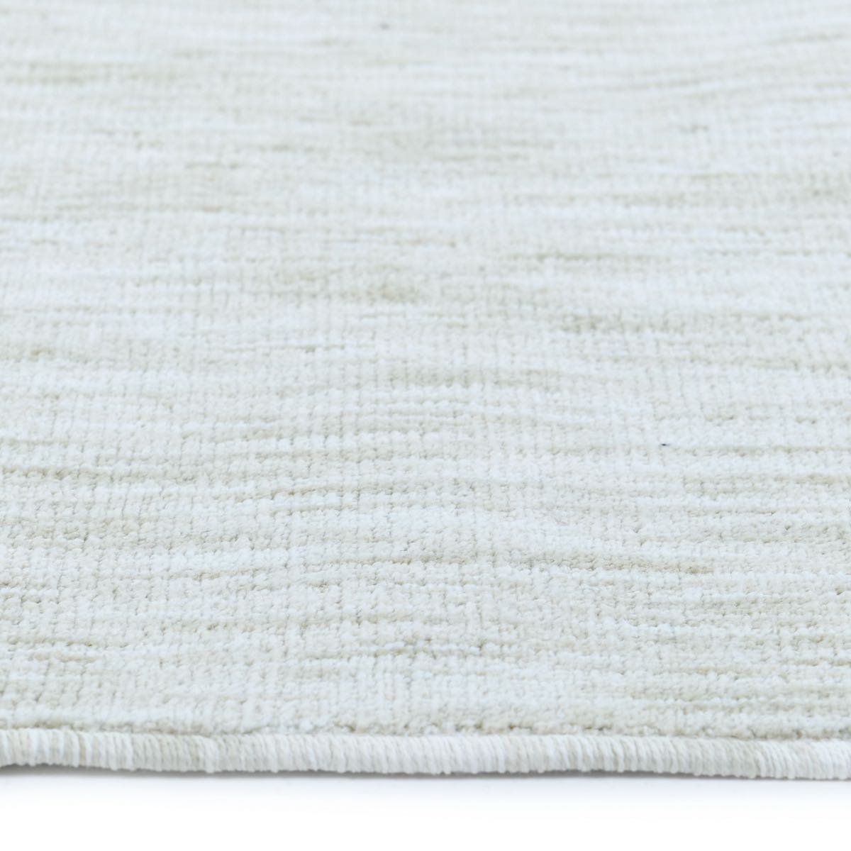COD-12 Well Woven Moor Washable Rug: Close-up of a textured white rug with a subtle cream pattern on a white background