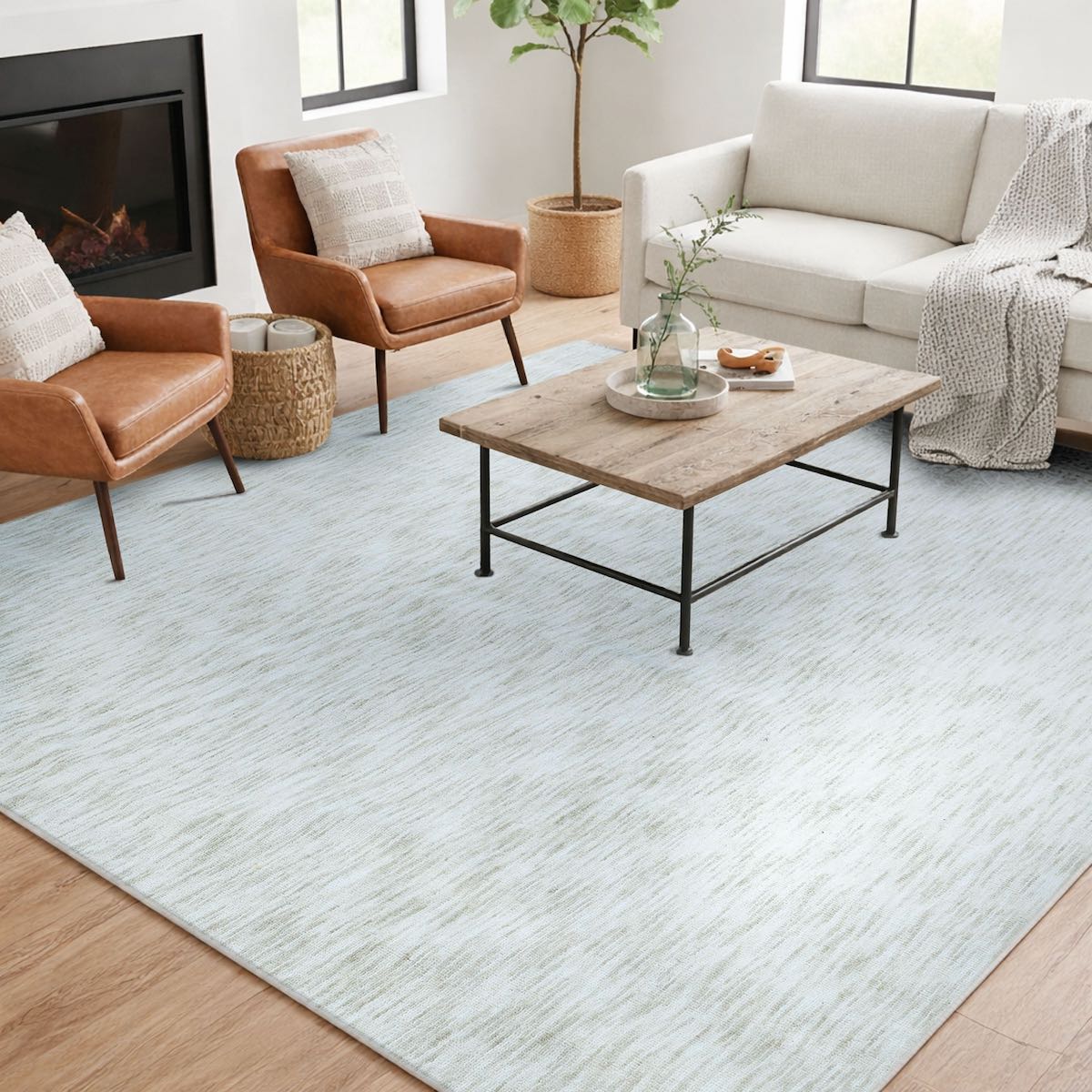COD-12 Well Woven Moor Washable Rug - Modern living room with a heathered ivory rug, brown leather chairs, and a wooden coffee table with metal legs