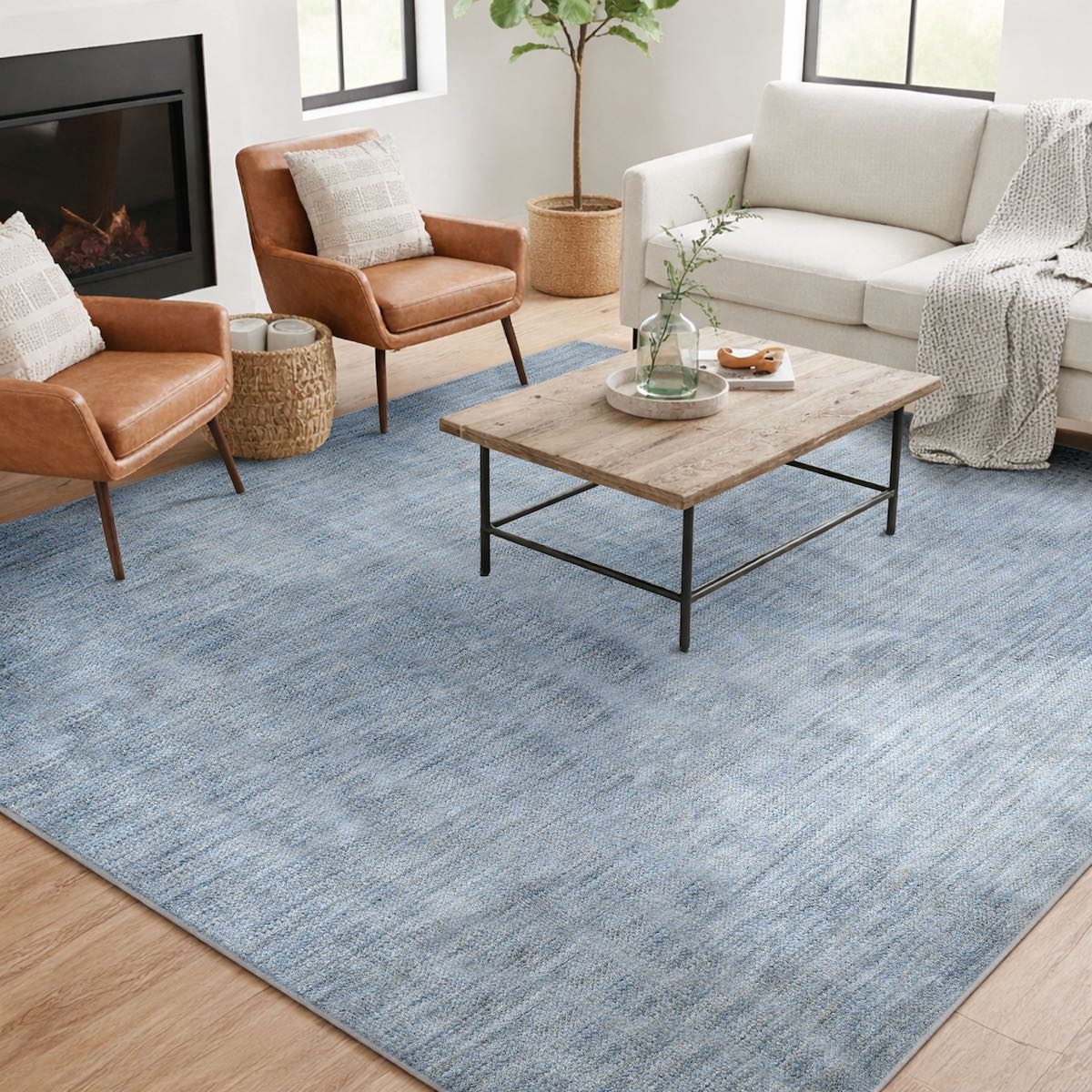 COD-17 Well Woven Moor Washable Rug - Living room with a light blue washable rug, brown chairs, and a wooden coffee table.