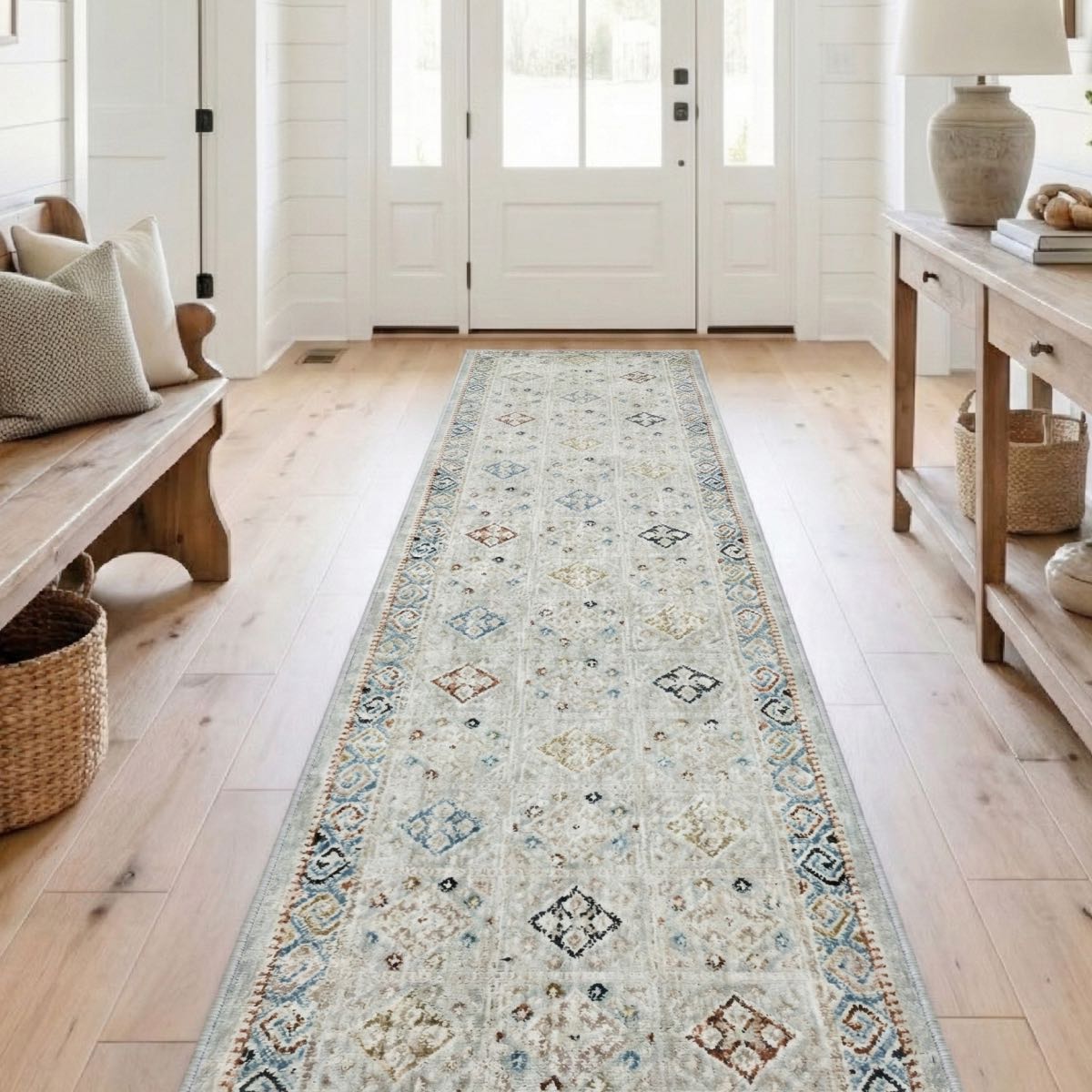 COD-21 - Long patterned entryway runner rug on a wooden floor in a room with a bench and table.