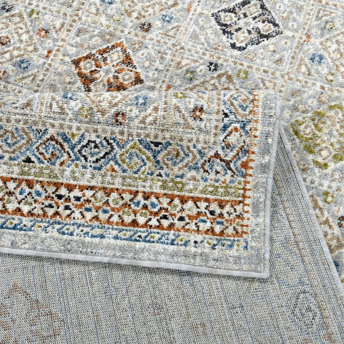 COD-21 Well Woven Mere Washable Rug: Close-up of a multicolor eco-friendly rug with intricate designs and a soft, textured surface.