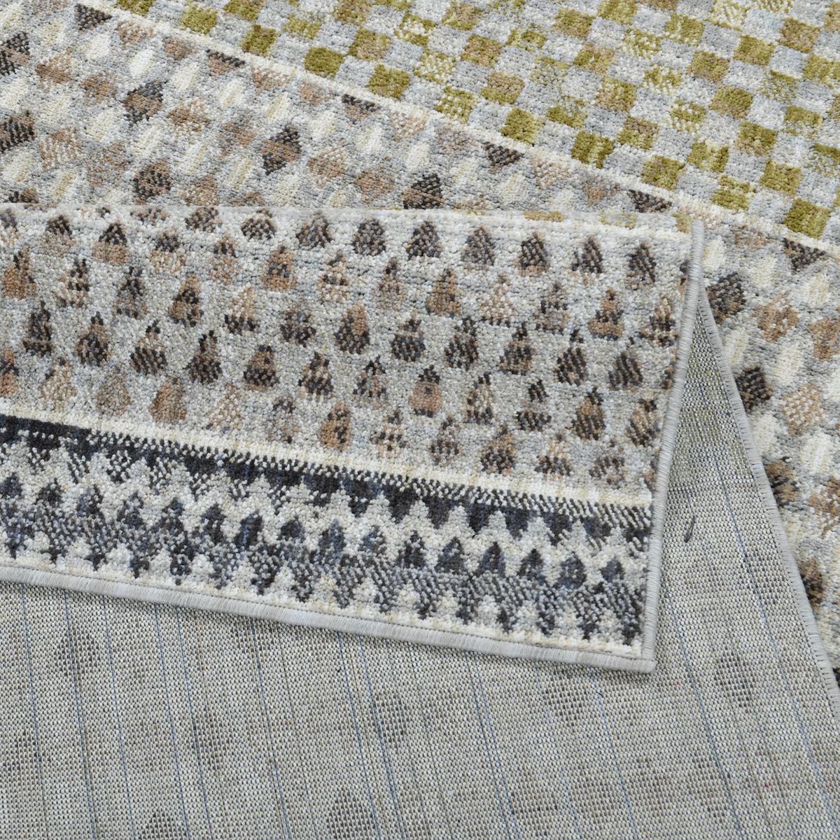 The COD-31 Well Woven Wynn Washable Rug folded over itself to show its soft pile surface, gentle backing, and dimensional color palette