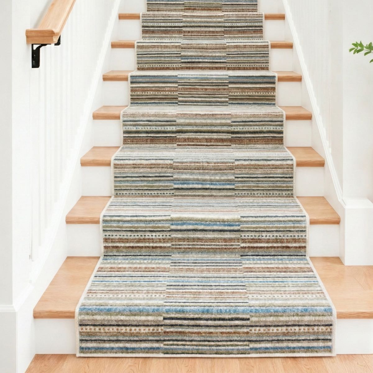 COD-41 - Striped staircase runner rug on a staircase with wooden steps and white walls.