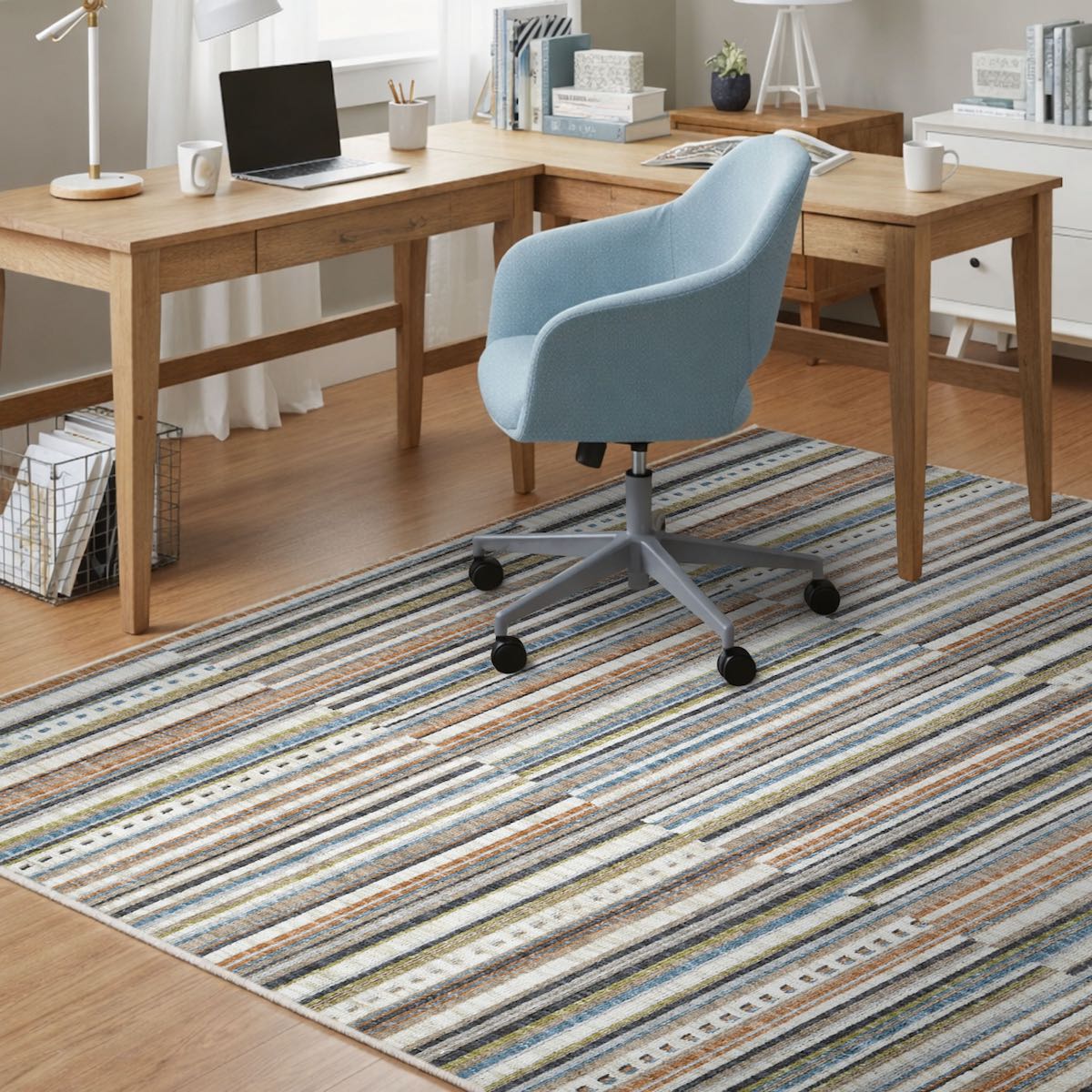 COD-41 Well Woven Thane Washable Rug - Home office with wooden L-shaped desk, blue chair with wheels, and a multicolor striped rug.
