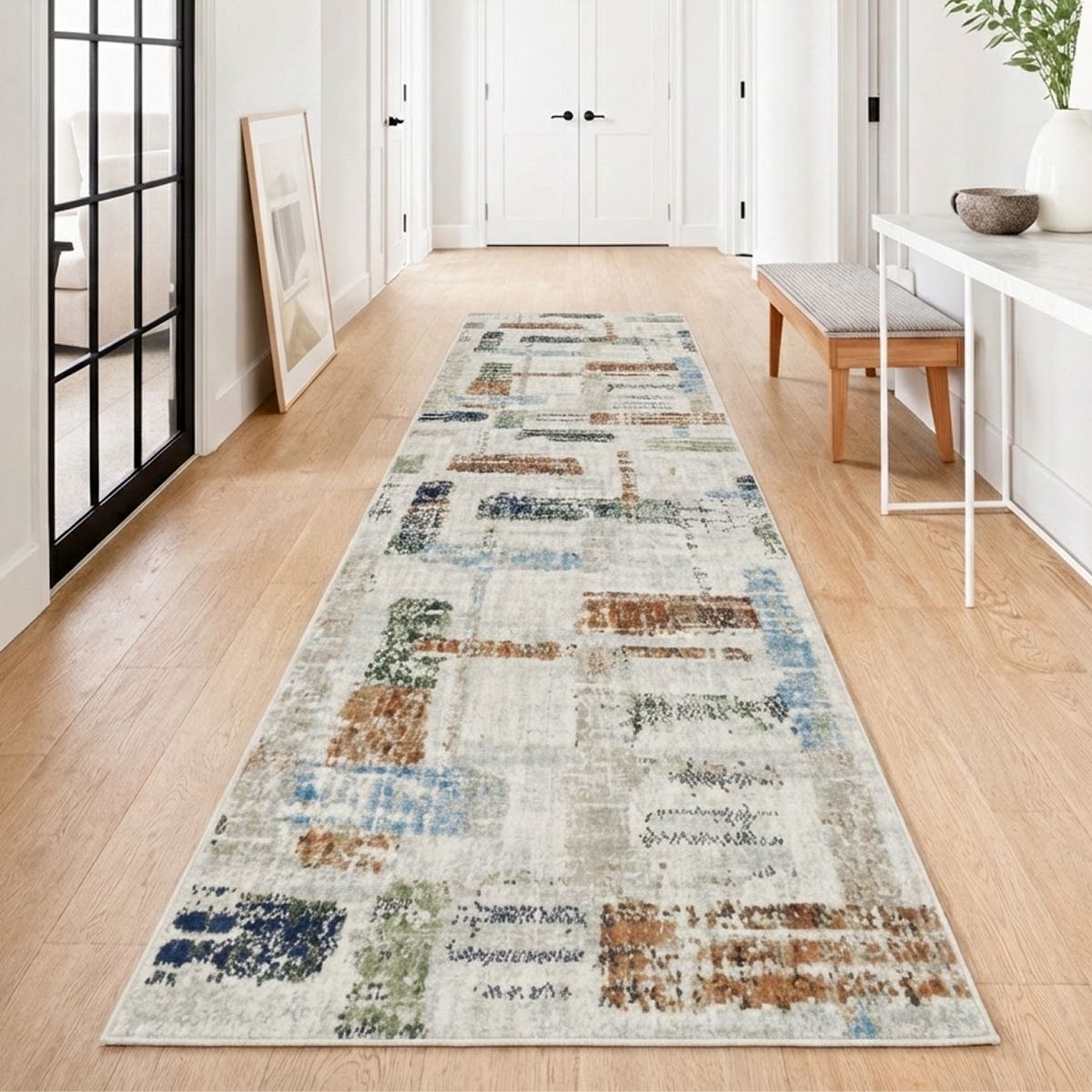 COD-51 - Long rectangular runner rug with a geometric pattern on a wooden floor in an artistic home hallway setting.