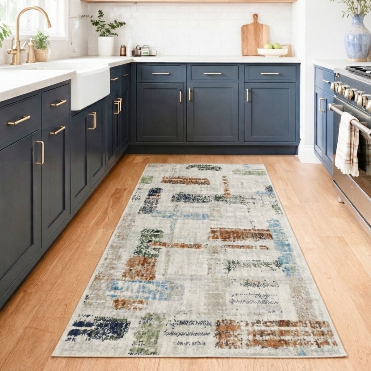 COD-51 - Kitchen with blue cabinets, a multicolored abstract washable rug on wooden flooring, and kitchen appliances.