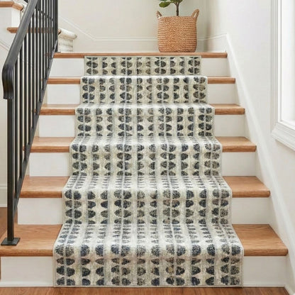 COD-81 - Patterned stair runner on a wooden staircase with a plant in the background.