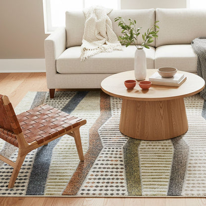 ELM-21 Well Woven Ridge Washable Area Rug: Living room with a beige sofa, wooden coffee table, and modern geometric rug anchoring the space.