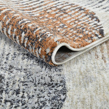 ELM-31 Well Woven Vale Washable Area Rug: Detail shot of a patterned rug with brown, beige, and gray colors on a light gray background