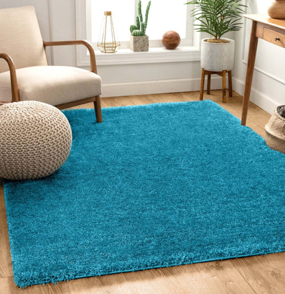 Feather Collection Liza  Blue Shag Rug –   Sparkly, Plush, Minimalist Glam - Well Woven - Soft teal rug in a living room