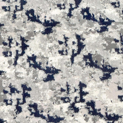 A close up view of the Shadowplay Custom Size Runner's grey and blue abstract rug pattern