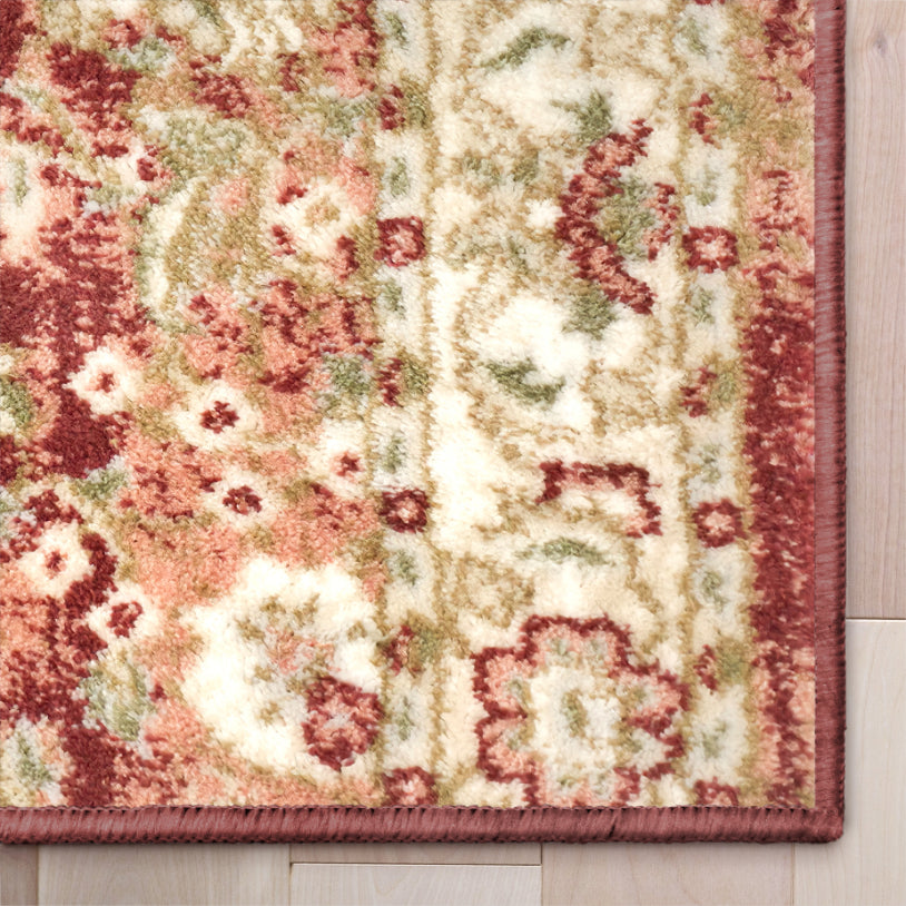 IND-100 Decorative crimson rug with floral pattern on a wooden floor