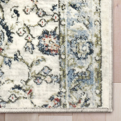 IND-102 Patterned rug with floral design on a wooden floor