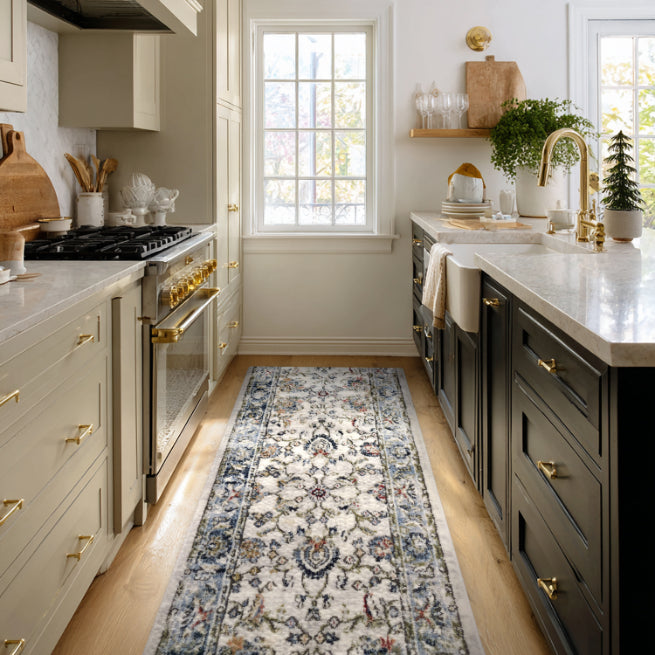 IND-102 Modern kitchen with gray cabinets, white countertops, and a patterned ivory runner rug on the floor.