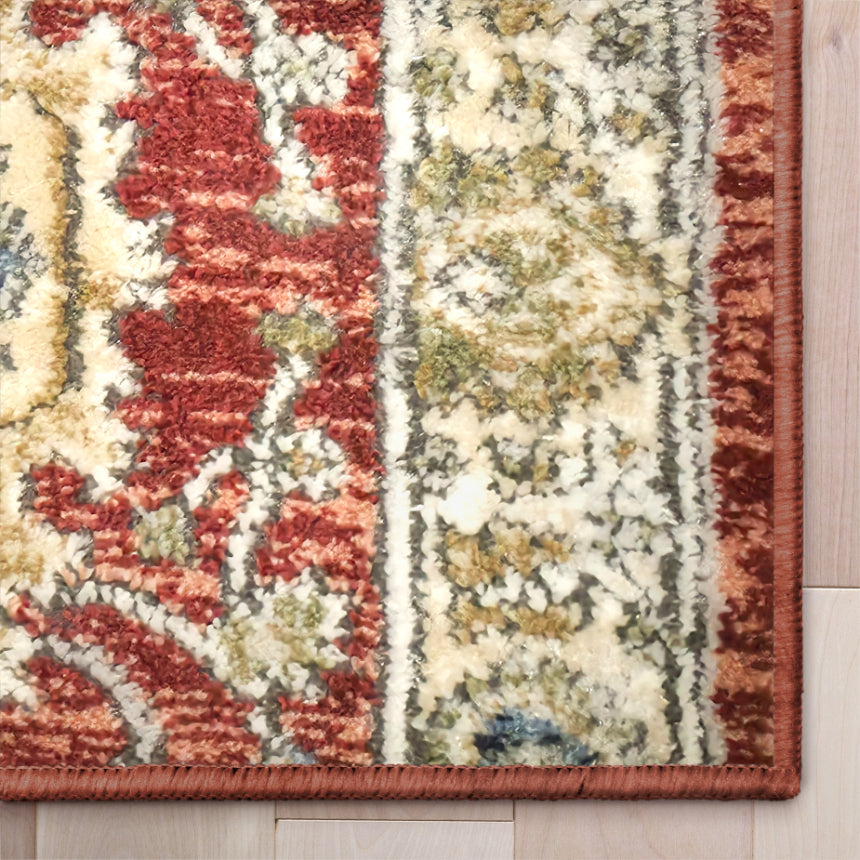 IND-130 Patterned rug with red, beige, and blue colors on a wooden floor.