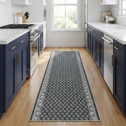 Charcoal patterned kitchen runner rug on wood floor in a modern kitchen. The runner is Apollo Windsor Midnight Ash from Well Woven.