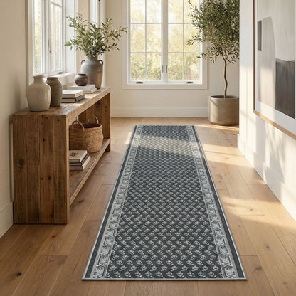 Charcoal patterned hallway runner rug on light wood floor in a bright, neutral entryway. The runner is Apollo Windsor Midnight Ash from Well Woven