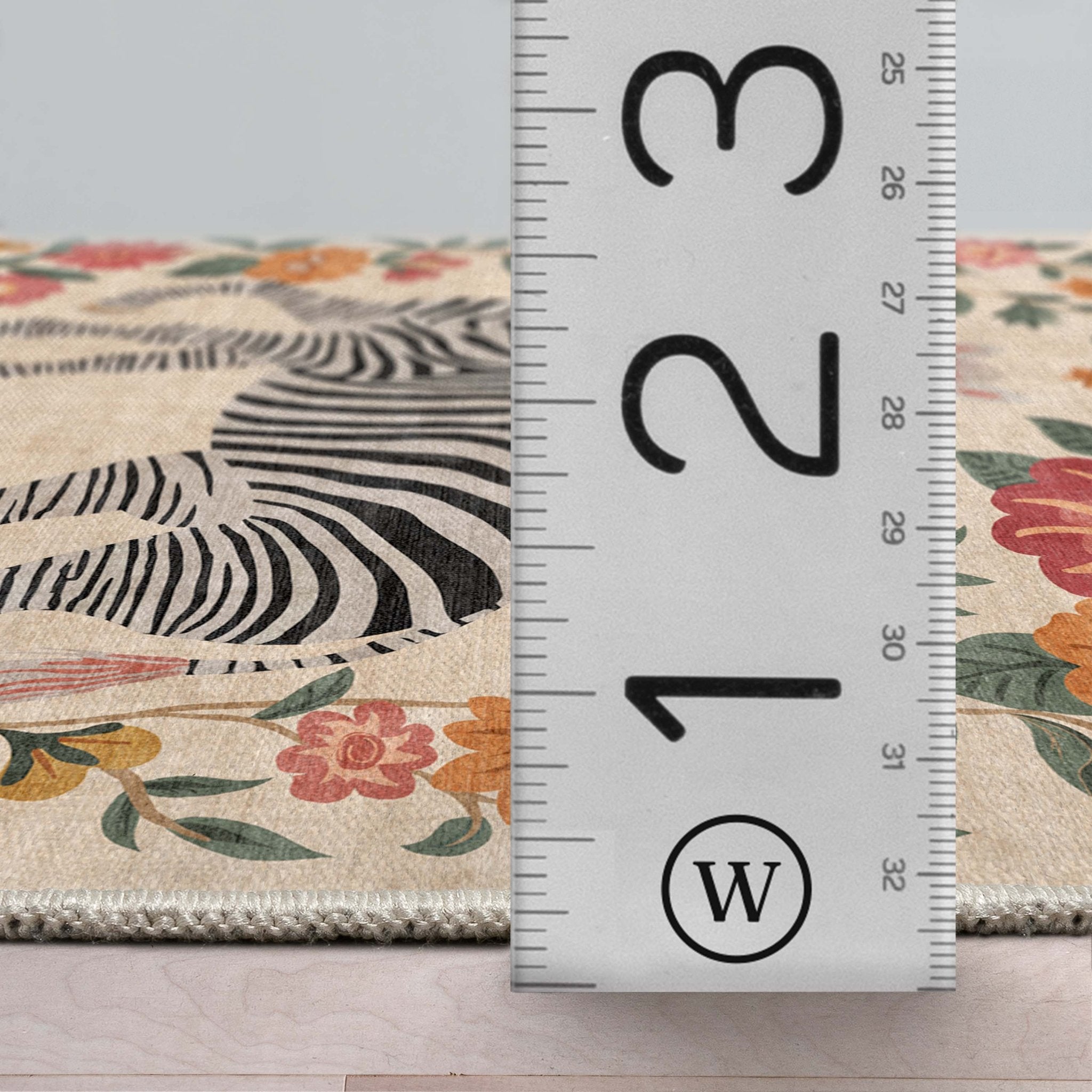 A profile detail image of the Zebra's Haven Ivory Multi Rug Perfect for Living Room, Dining Room, Bedroom and Kitchen with a ruler showing the rug's thickness