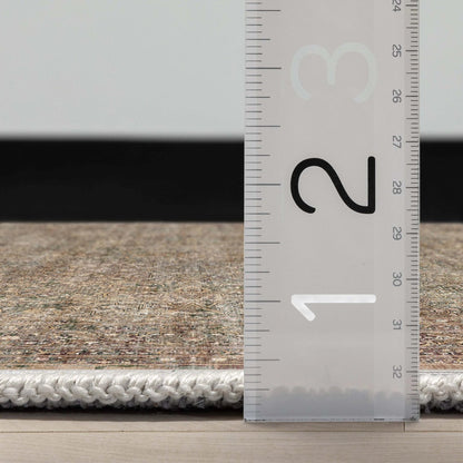 Close up profile of the Asha Juliette Beige Flatwoven Runner Rug with a ruler showing measurements on a wooden floor. 