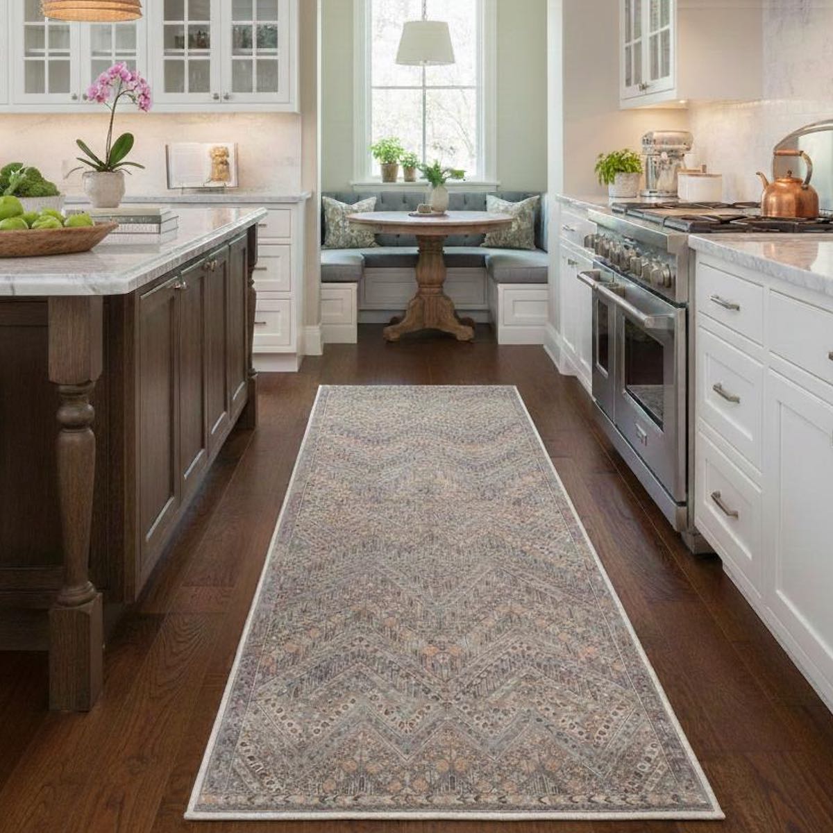 Placed down the center of the kitchen, the Anya Vintage Tribal Grey Custom Runner Rug by Well Woven adds warmth, texture, and subtle pattern without overpowering the bright cabinetry and finishes.