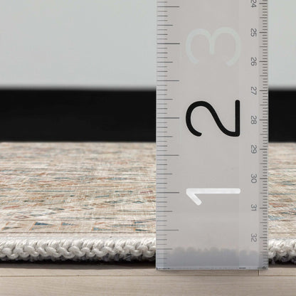 A side profile of the Asha Anya Ivory Flatwoven Custom Runner Rug with a ruler showing measurements on a wooden floor